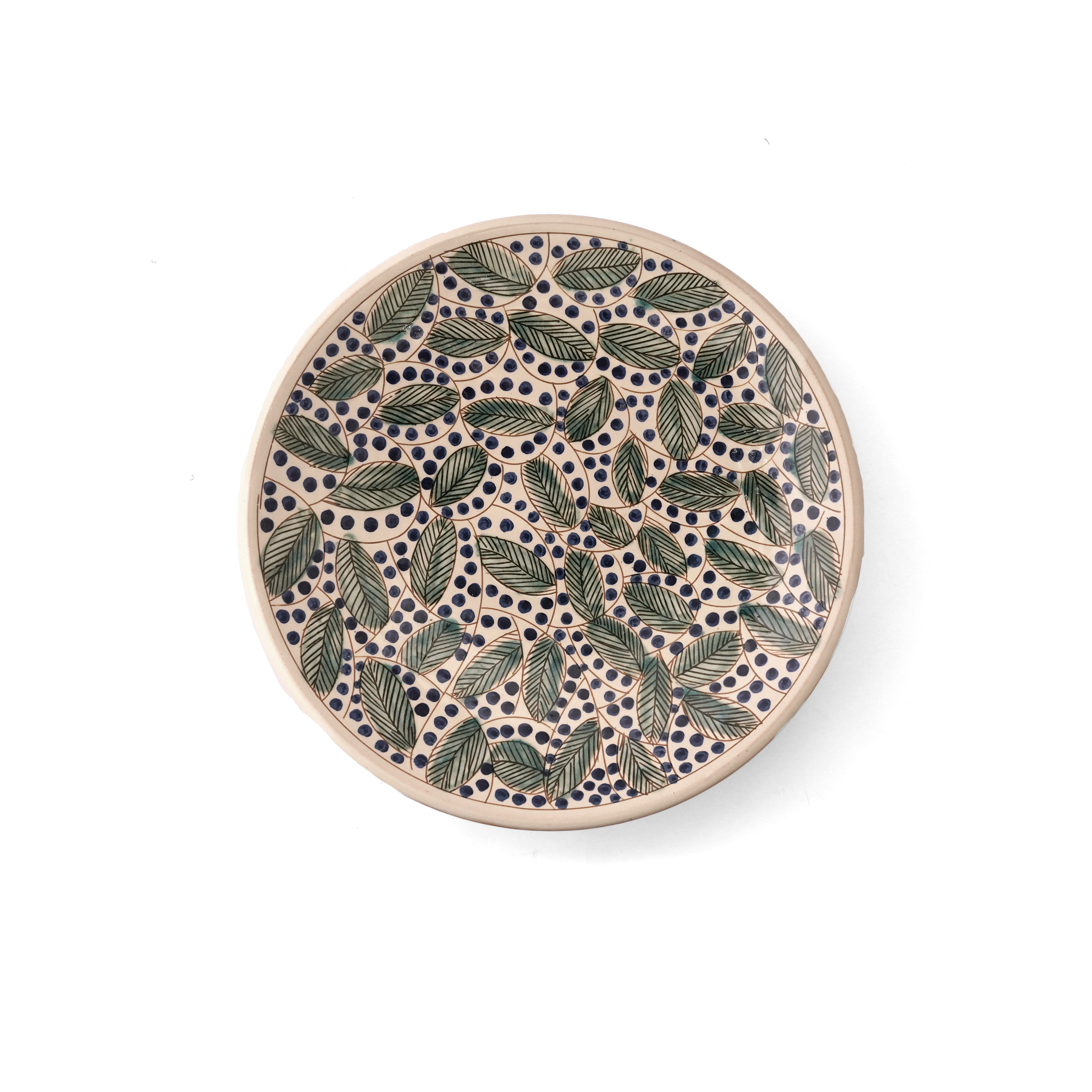 Round ceramic plate with leaf pattern on a white background