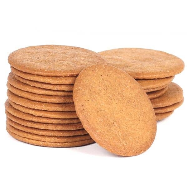 Stack of round, brown cork coasters on a white background