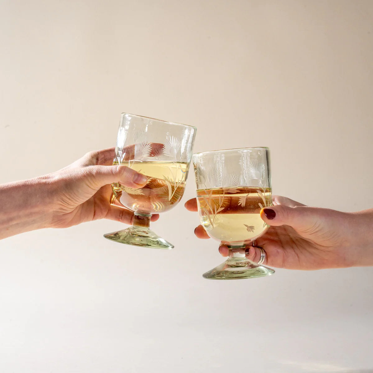 Hand-blown recycled glass wine glass with soft curves and airy bubbles