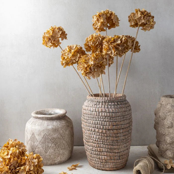 Faux hydrangea stem in warm walnut tones styled in a ceramic Clotilde vase, by Abigail Ahern