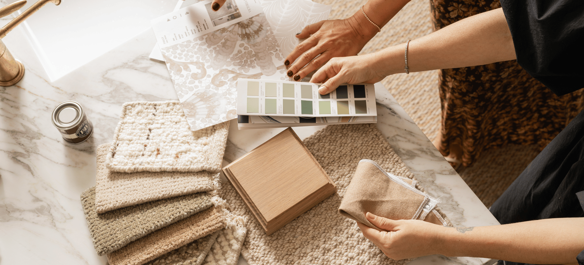 Designer reviewing fabric and paint swatches at a styling session, Calimia Home trade program in Coral Gables