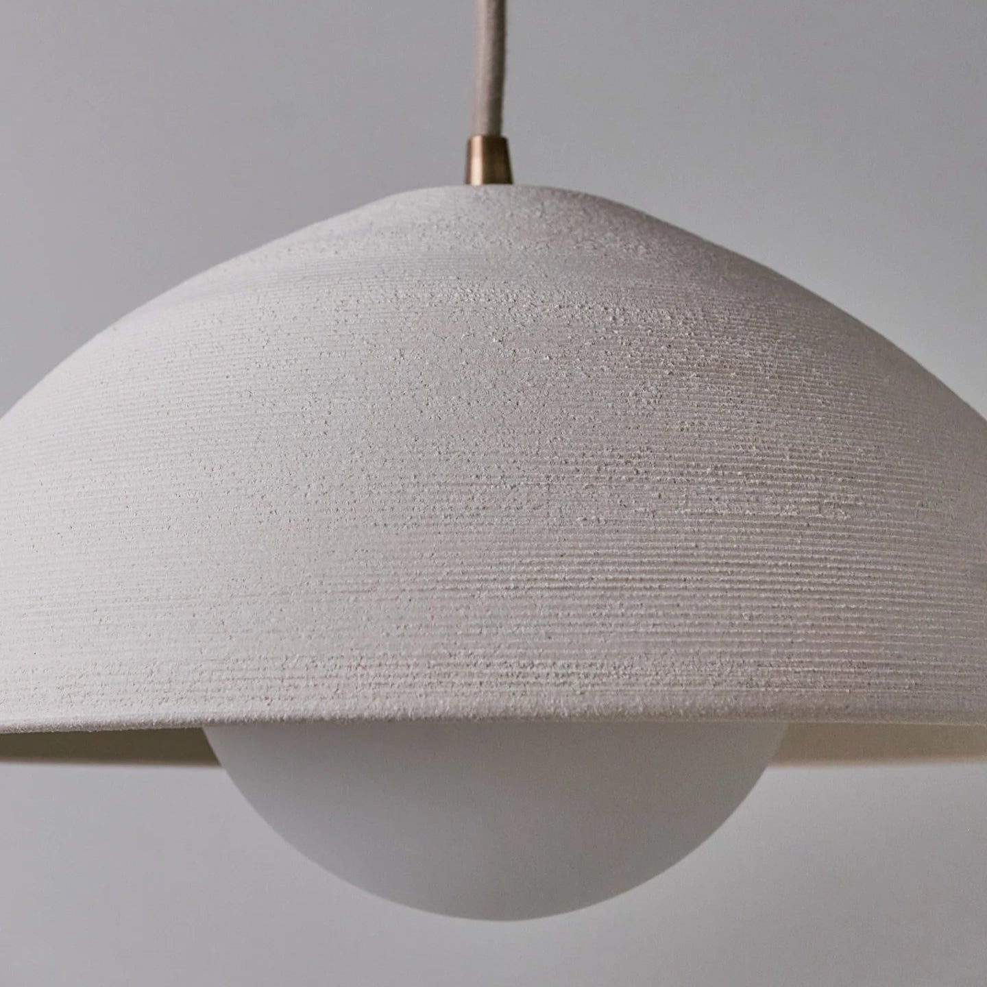 Textured pendant light with a neutral background