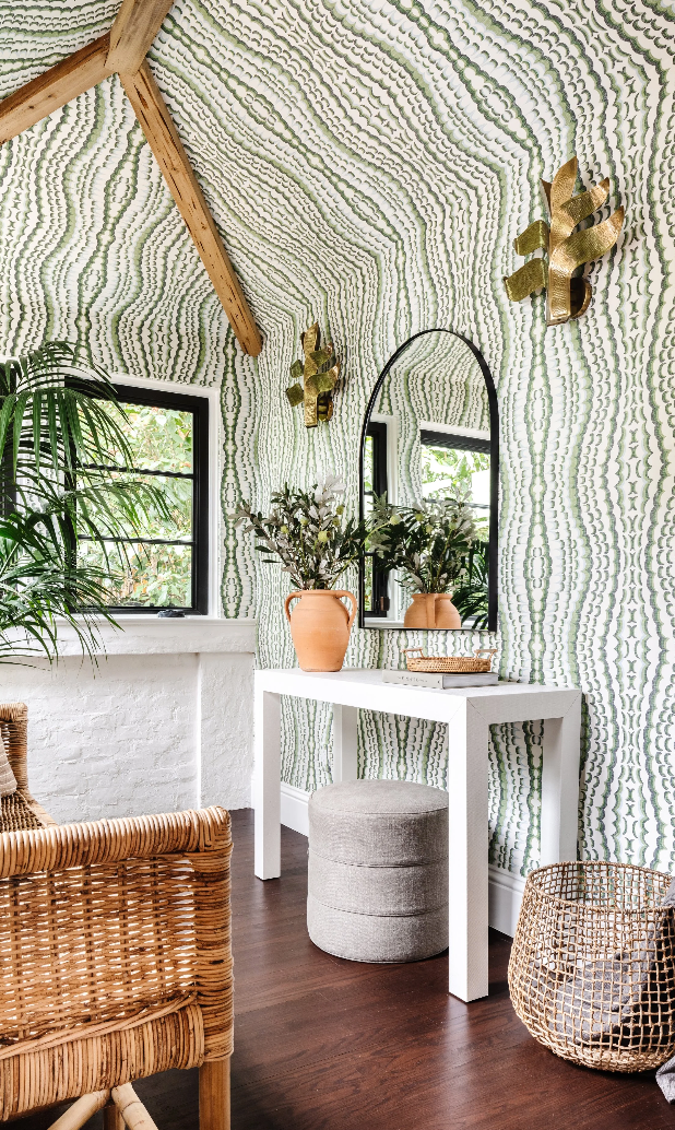 Decorative interior with textured wall, console table, and decorative items.