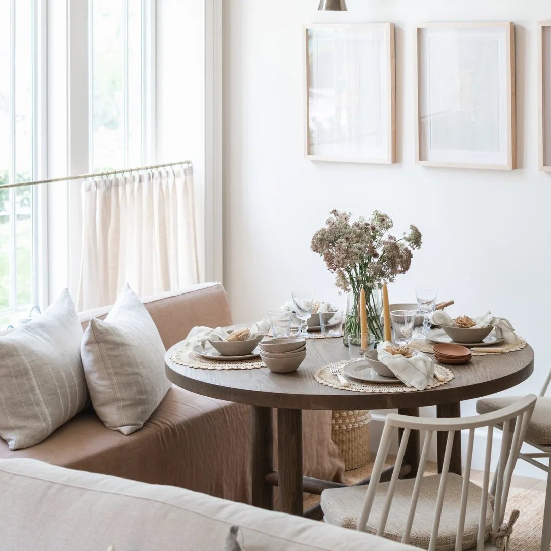 Galactic Triptych I above a dining nook with the Valencia X table, Lewis Windsor chairs and a linen sofa