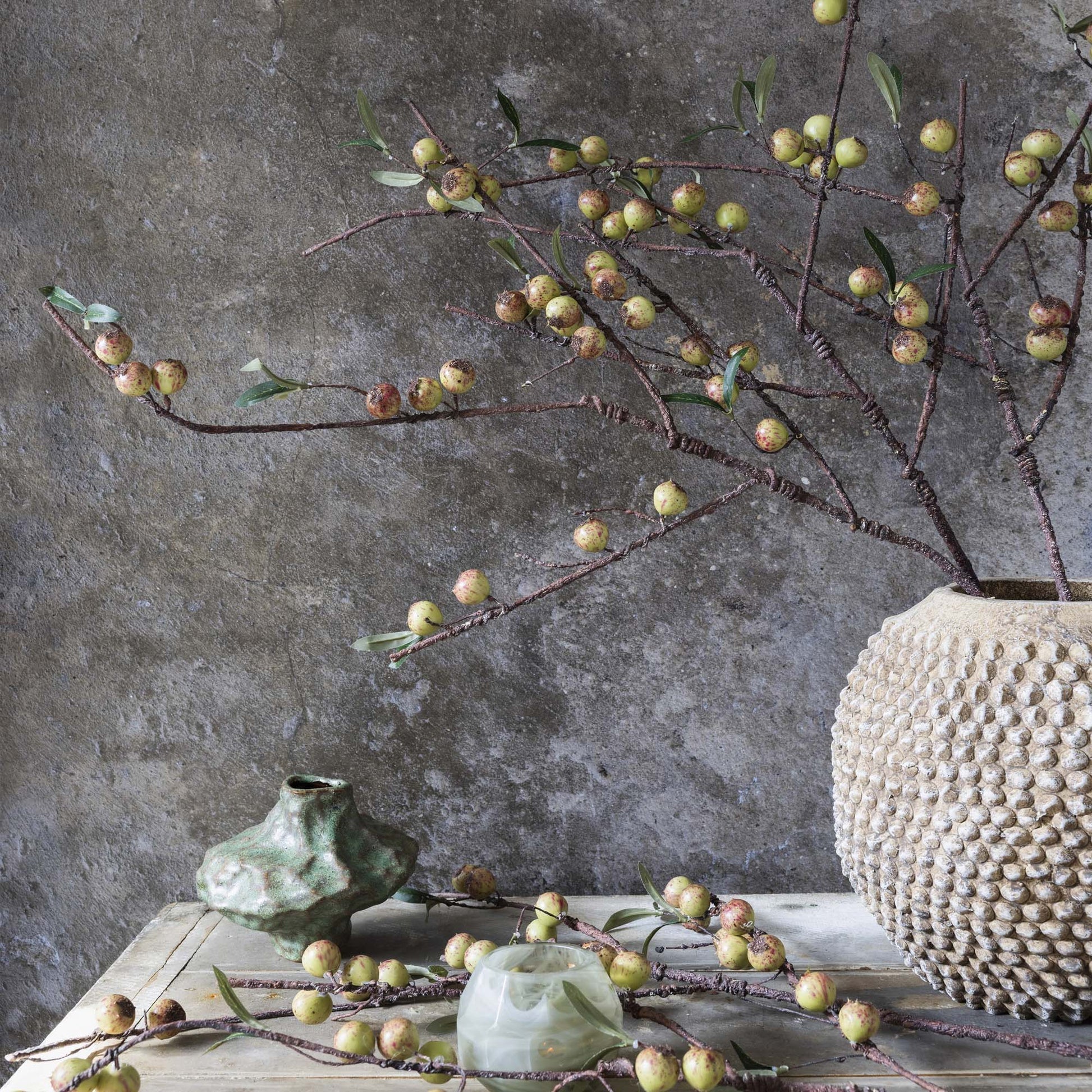 Artificial rosehip dappled stem detail showing earthy palette and organic form