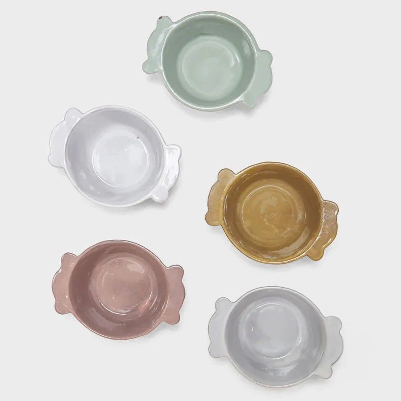 Il Buco Assisi ceramic bowls with side handles in assorted pastel colours including dove grey, pink, and ochre.