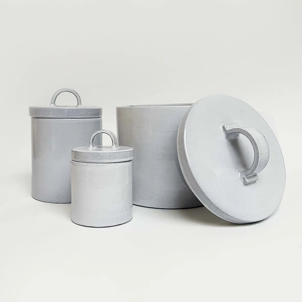 White Italian ceramic canister styled on a kitchen shelf