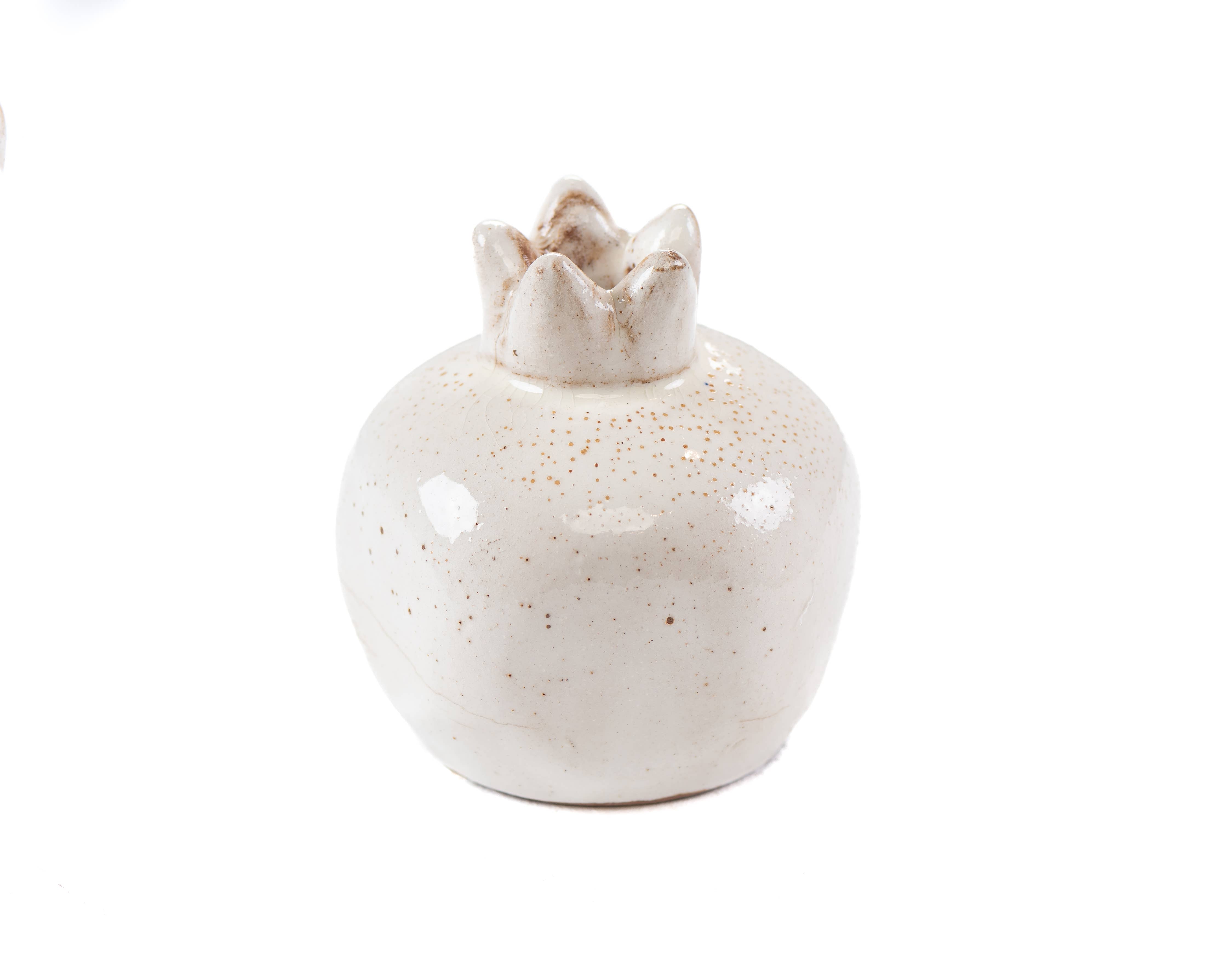 White ceramic pomegranate vase on a white background