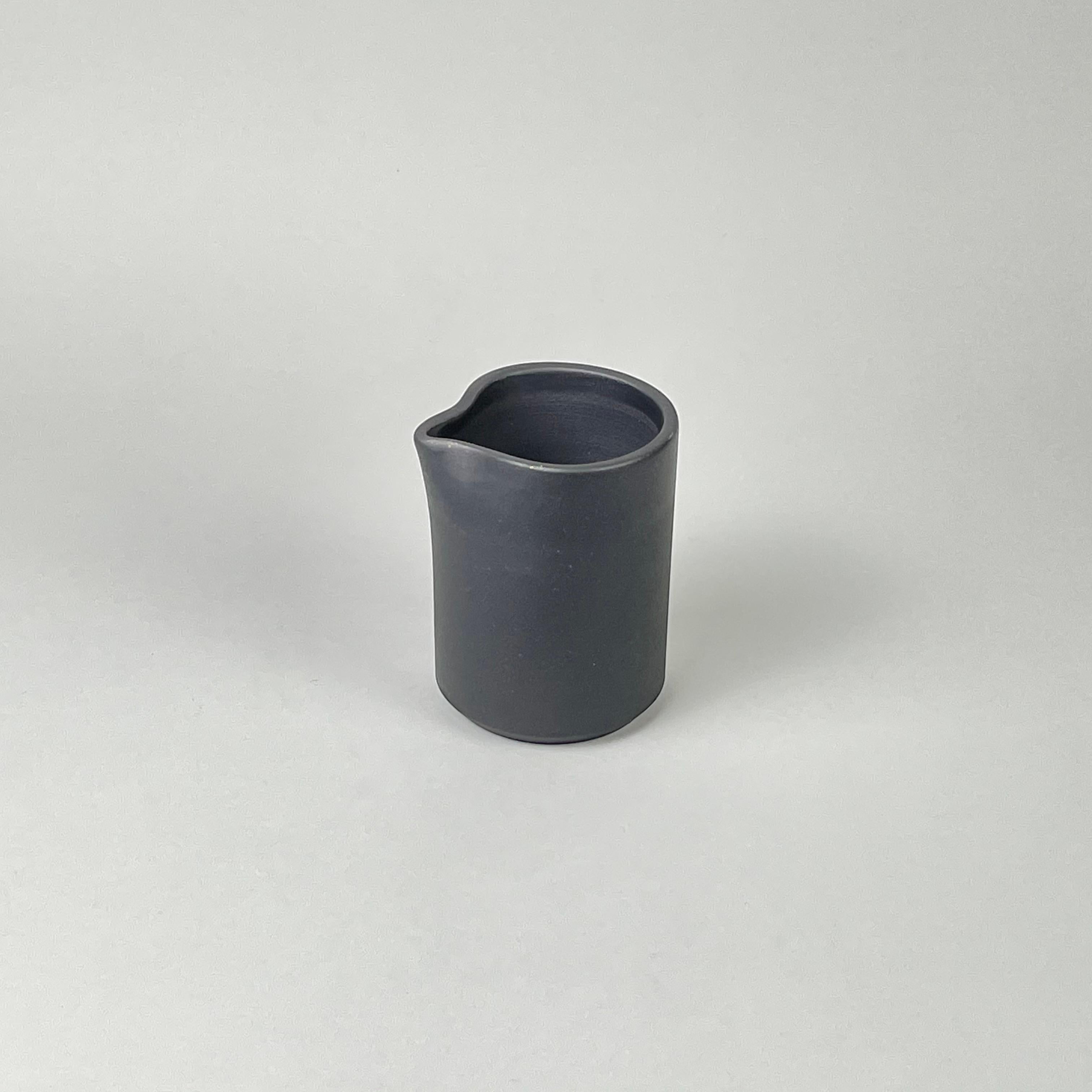 Bitters Co Barro Pitcher in matte black clay with a minimalist, unglazed burnished finish.