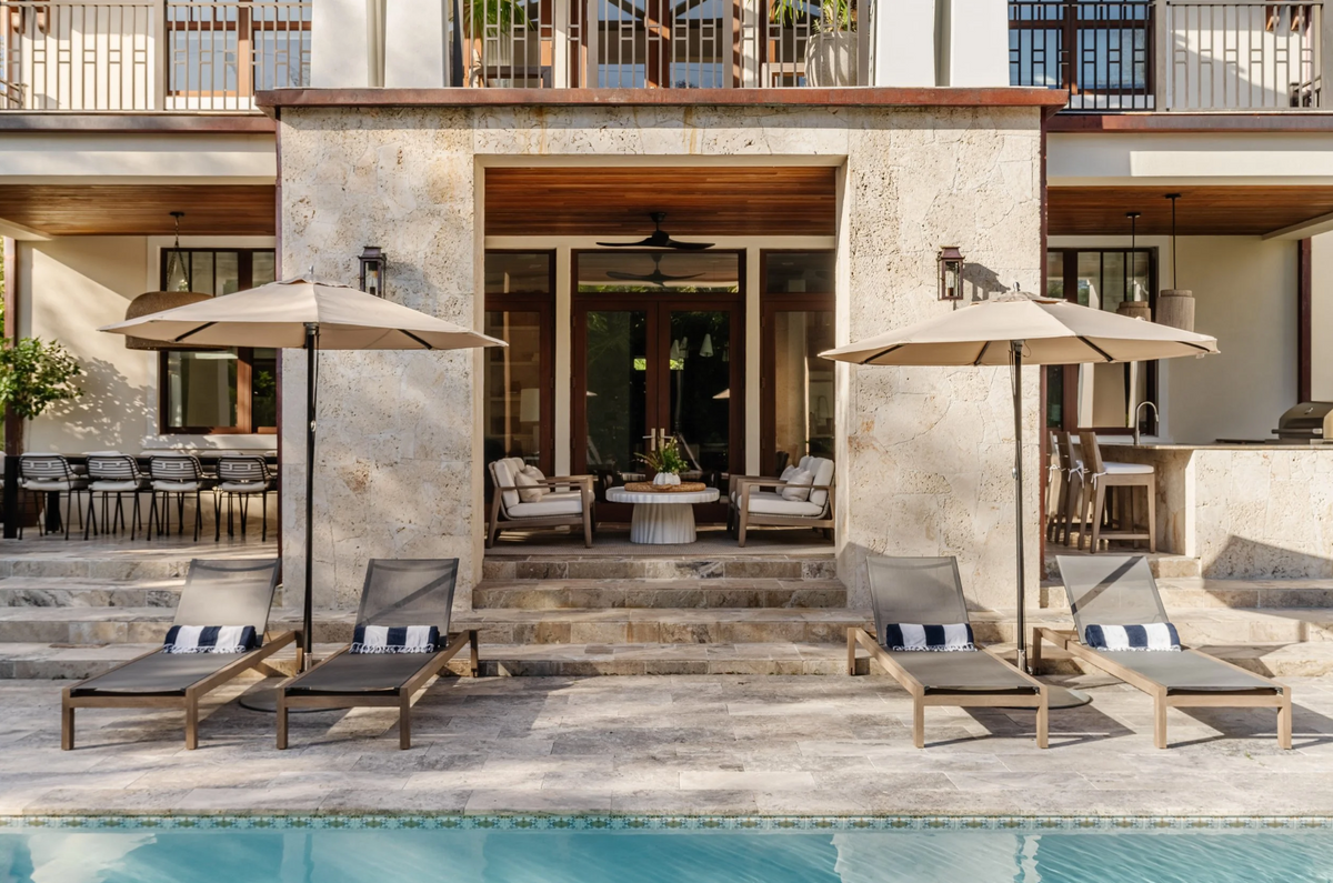 Rear loggia and pool terrace with shaded loungers at the Coral Way Craftsman residence
