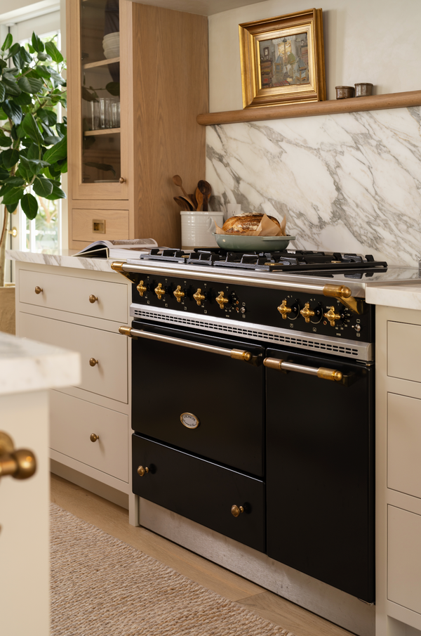Black Lacanche French range with brass trim in a custom Calimia Home kitchen