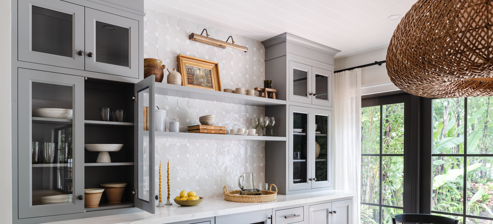 Gray custom butler's pantry cabinetry with glass doors and open shelving by Calimia Home