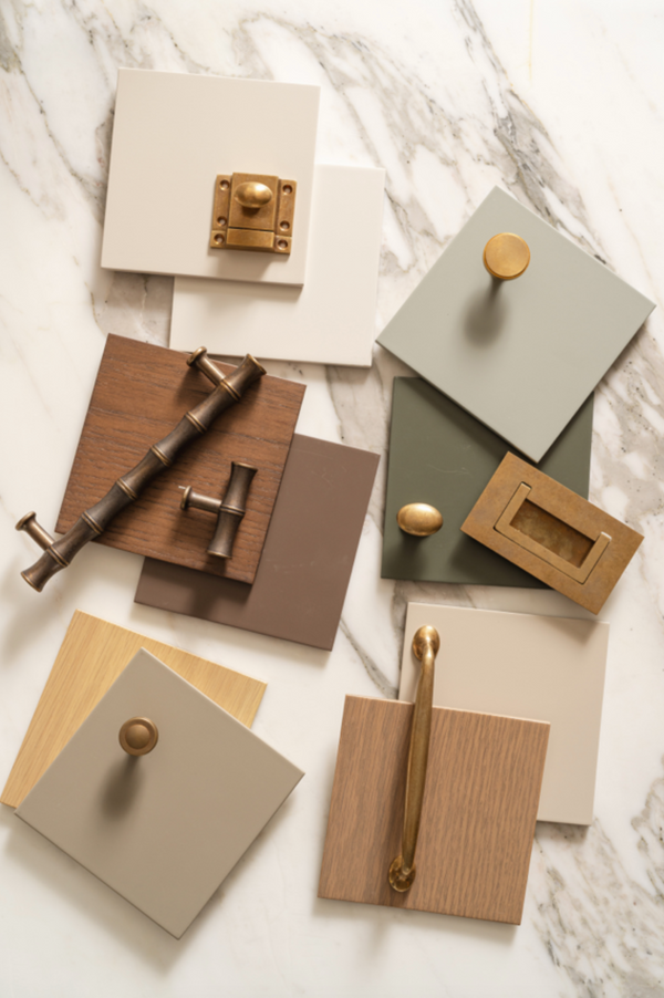 Stoffer Home Cabinetry Classic Line paint and wood finish samples with brass hardware on marble