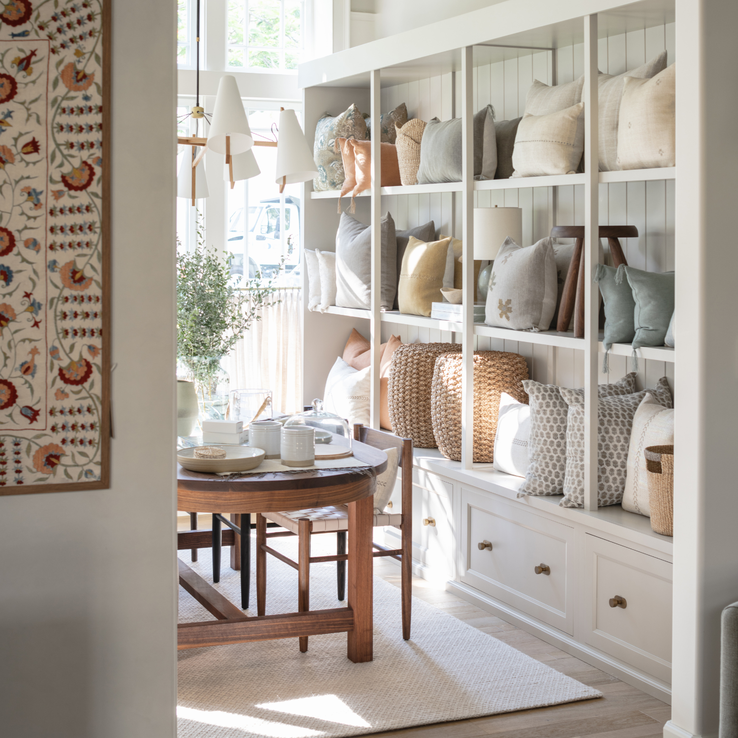 Display shelves styled with pillows, baskets and tableware at the Calimia Home studio showroom