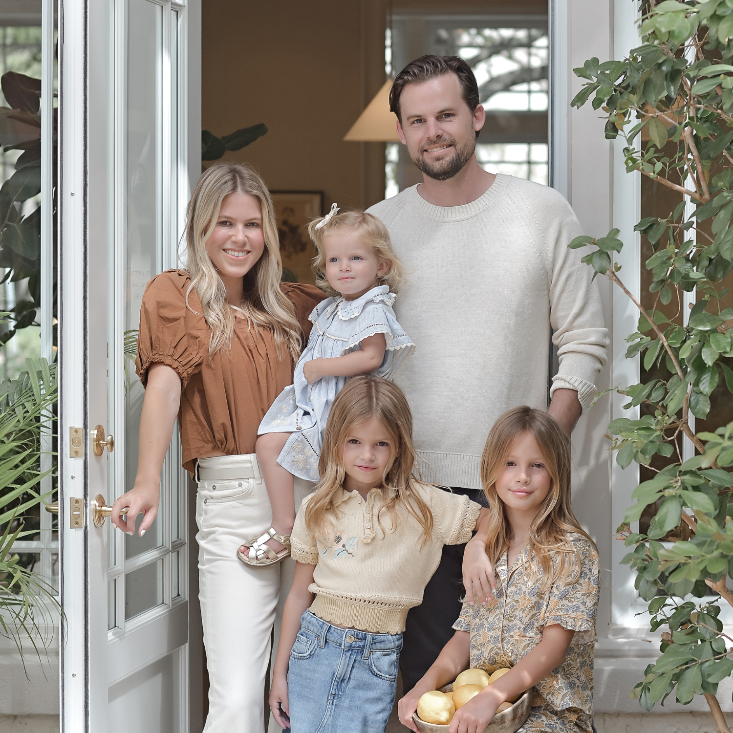 Calimia Home founders Gustaf Svensson and Monique Miller with their children at their home doorway