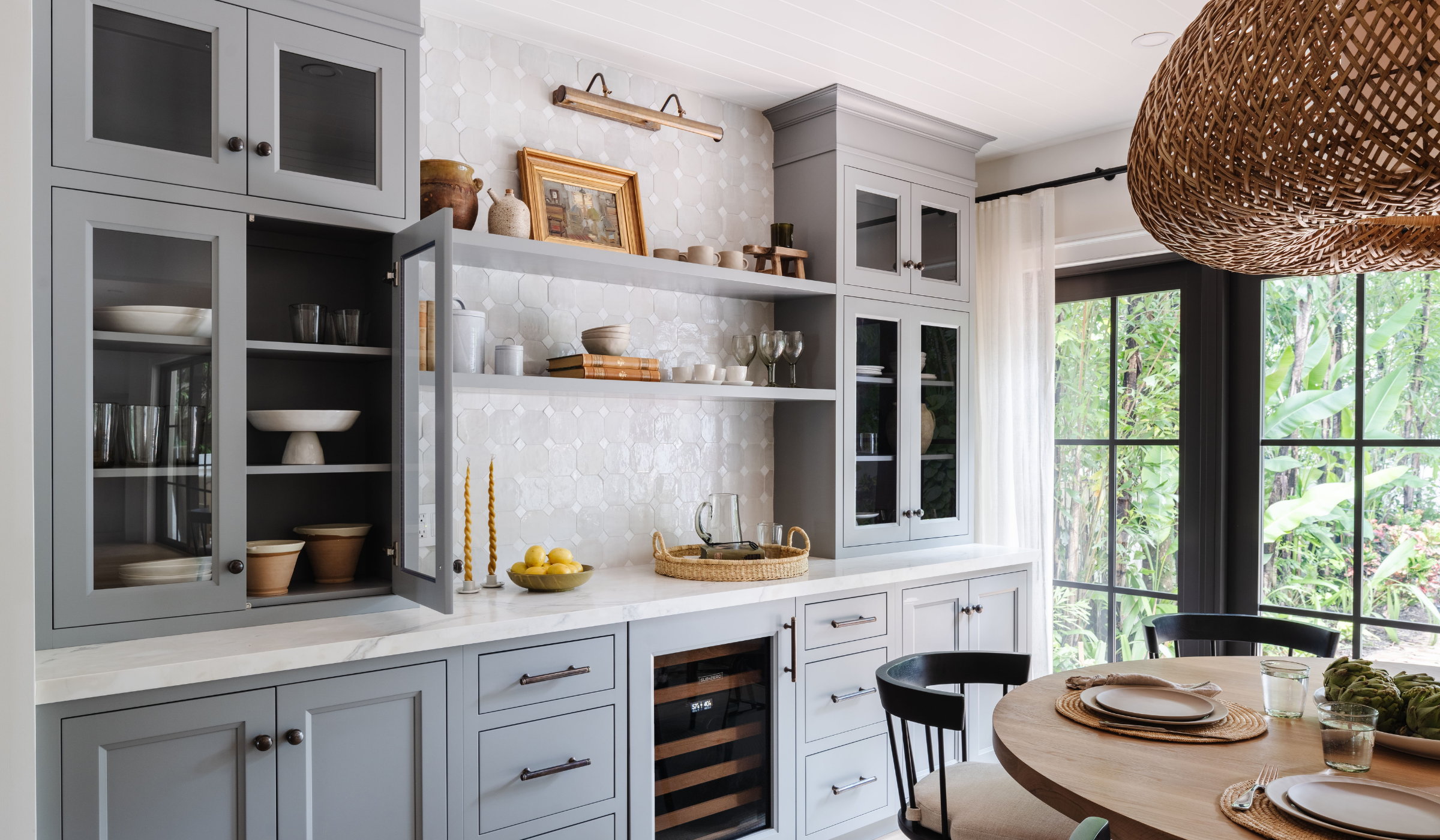 Gray butler's pantry with open shelving and wine fridge beside a breakfast nook