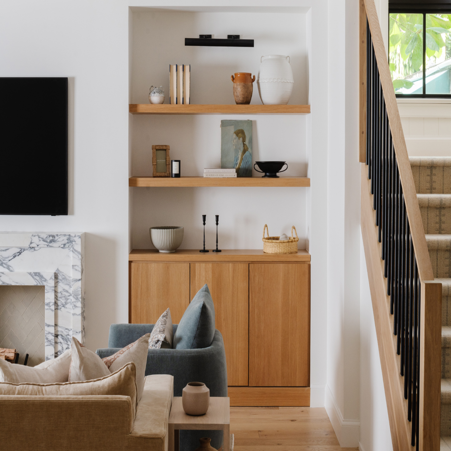 Styled oak shelving and living room vignette in a Calimia Home Miami project