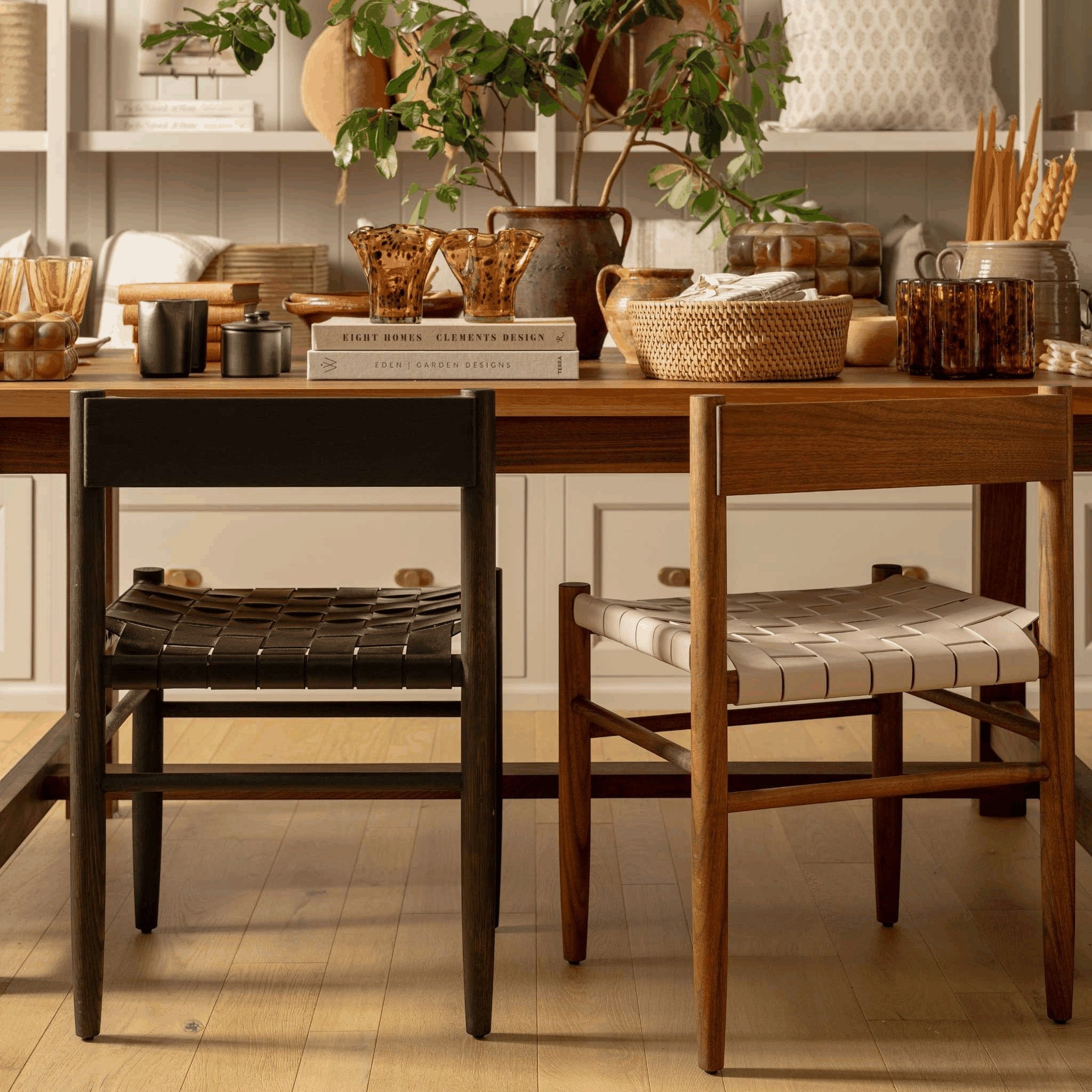 Calimia Home Gaon chairs with walnut and oak frames and woven cream and black leather seats at a dining table.