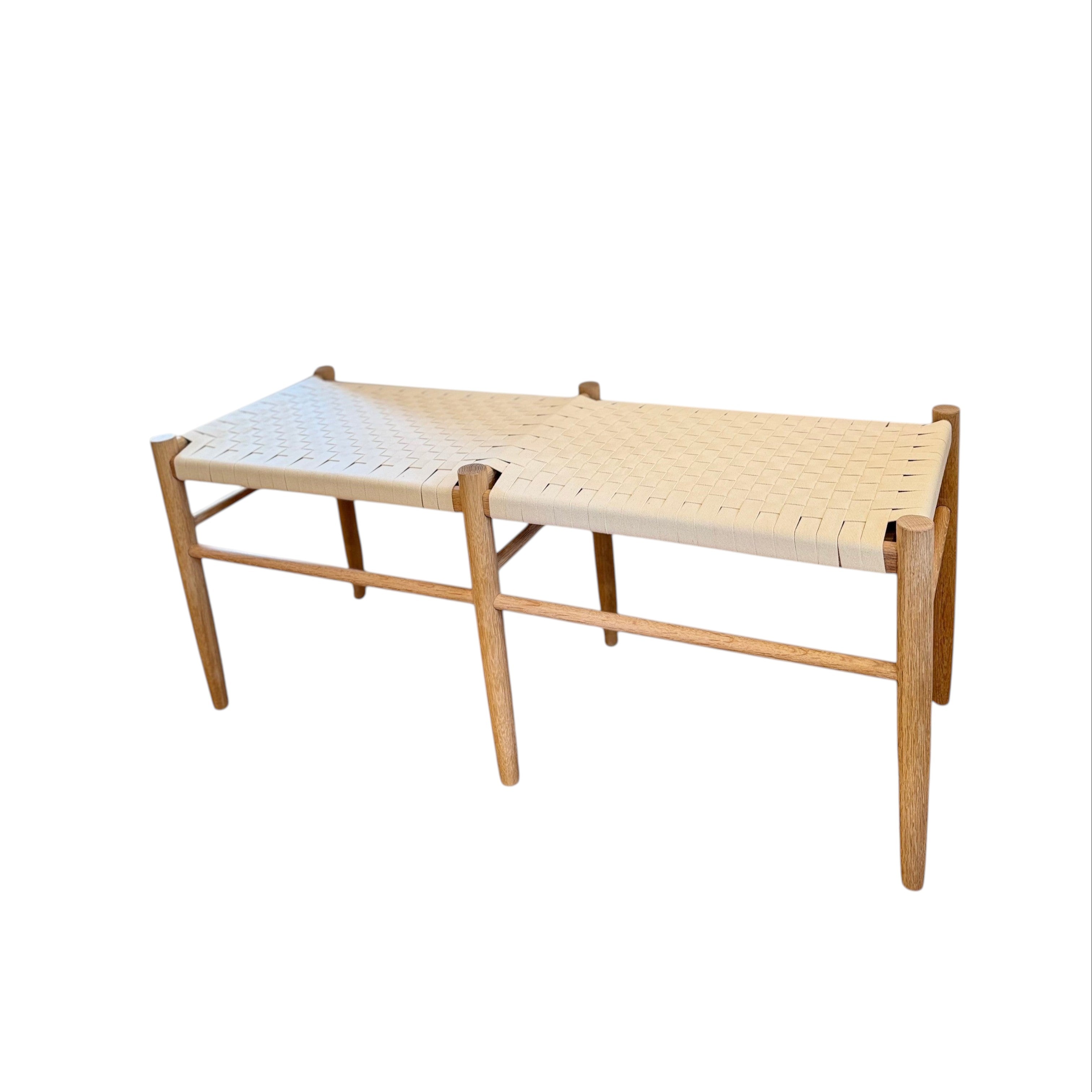 Calimia Home Gaon bench featuring a solid white oak frame and a handwoven white canvas ribbon seat.