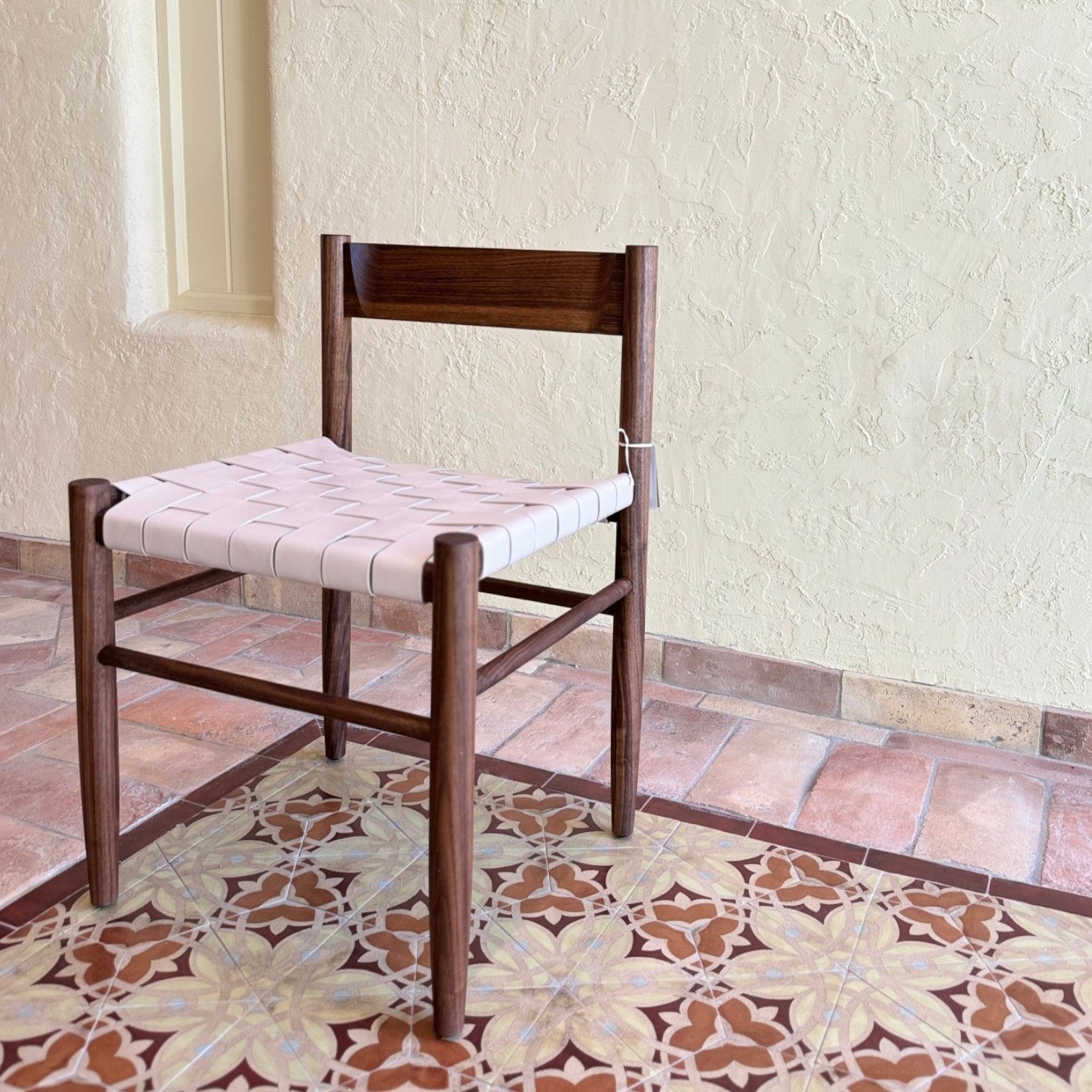 Calimia Home Gaon chair featuring a dark walnut oak frame and a woven cream leather seat in a modern minimalist style.