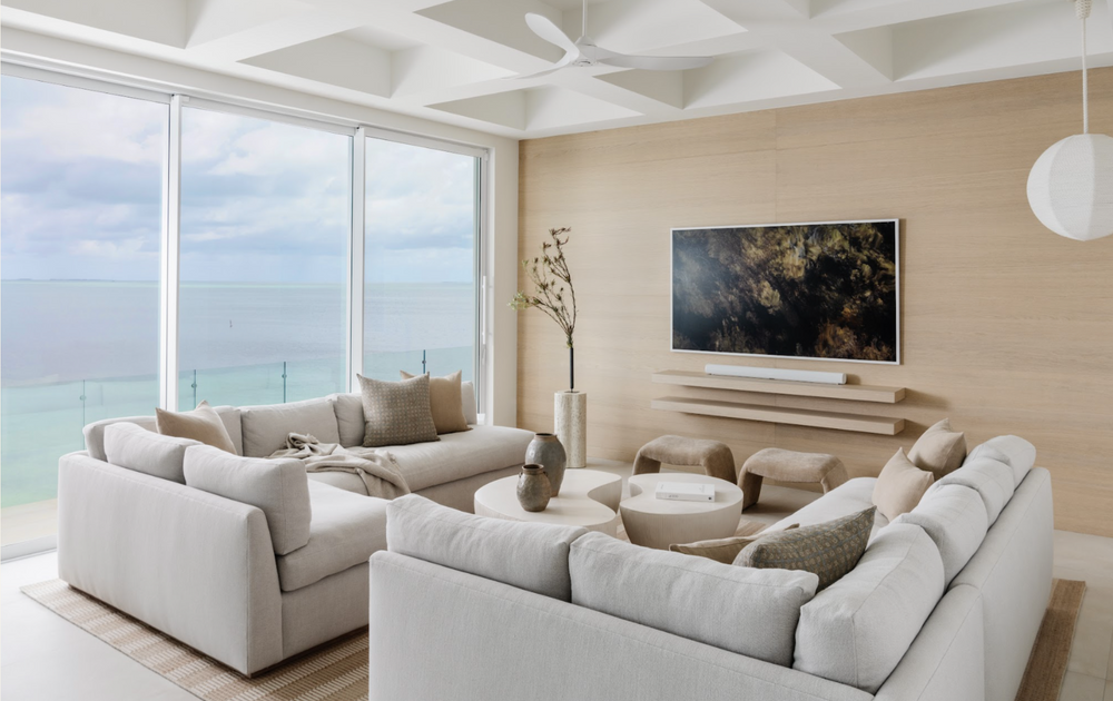 Serene coastal living room with plush white sectionals and ocean views in the Peaceful Waters home, Islamorada
