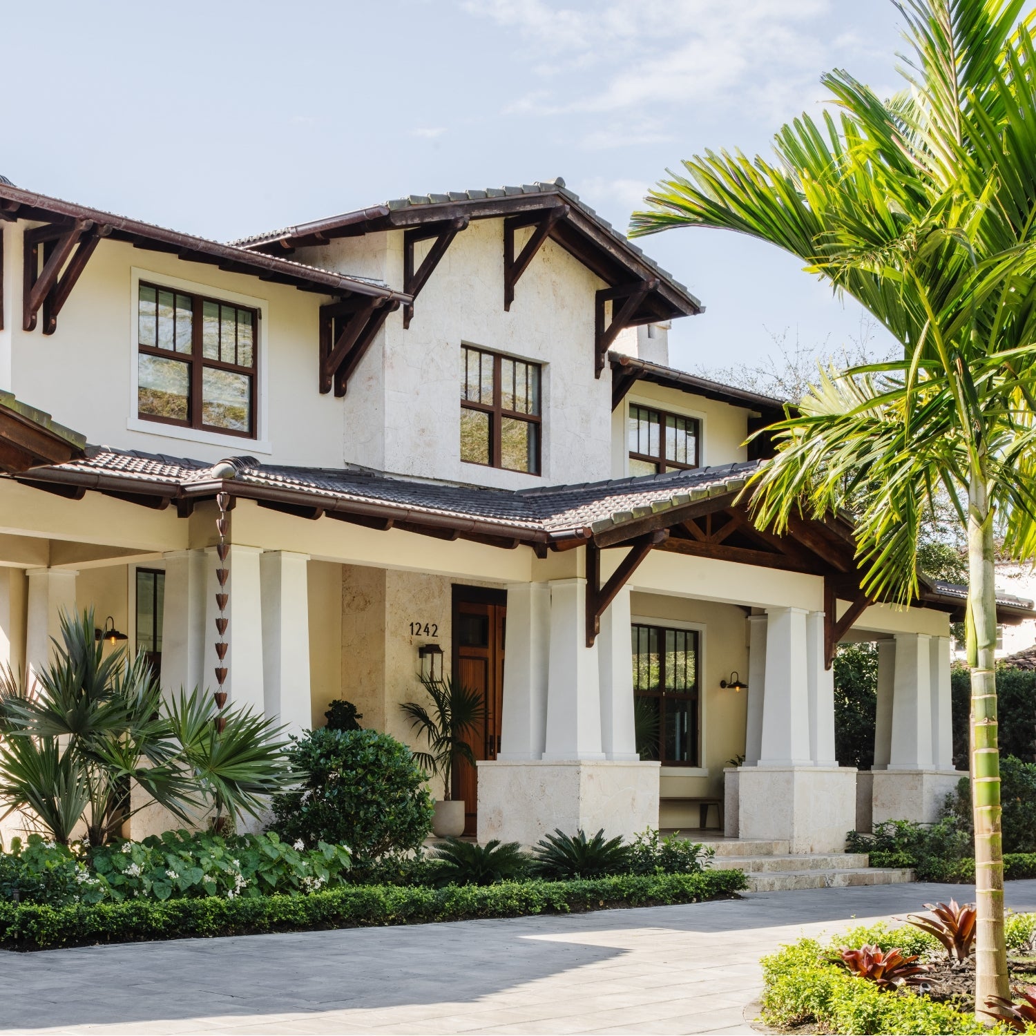 Craftsman home with coral stone columns and tile roof — Coral Way Craftsman, an interior design project in Miami