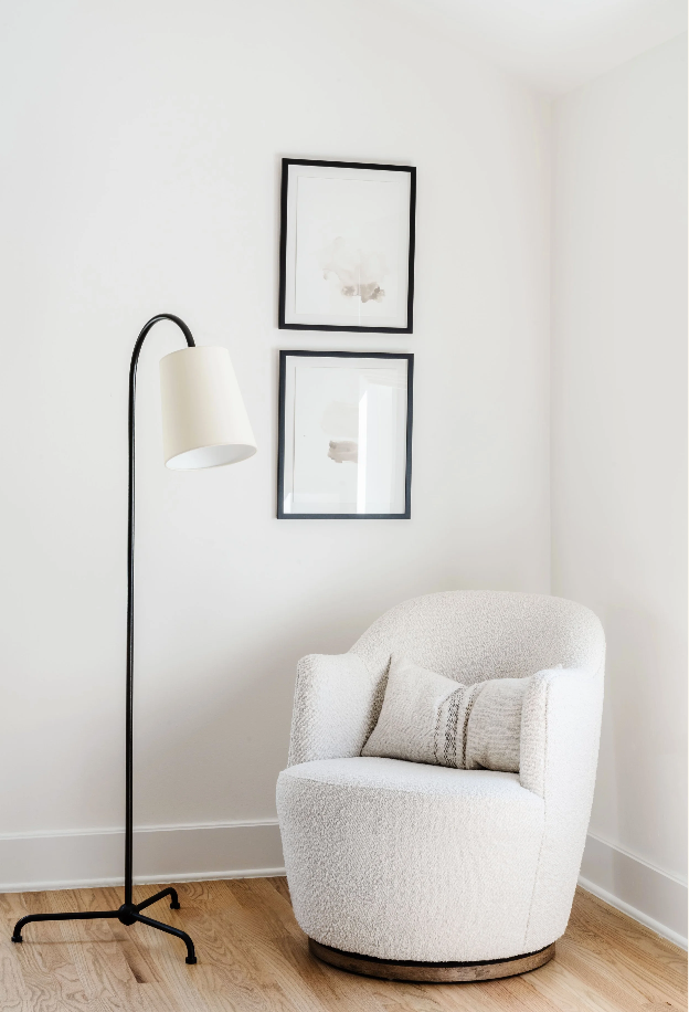 Boucle swivel chair and black arc floor lamp in a Coral Gables bedroom corner