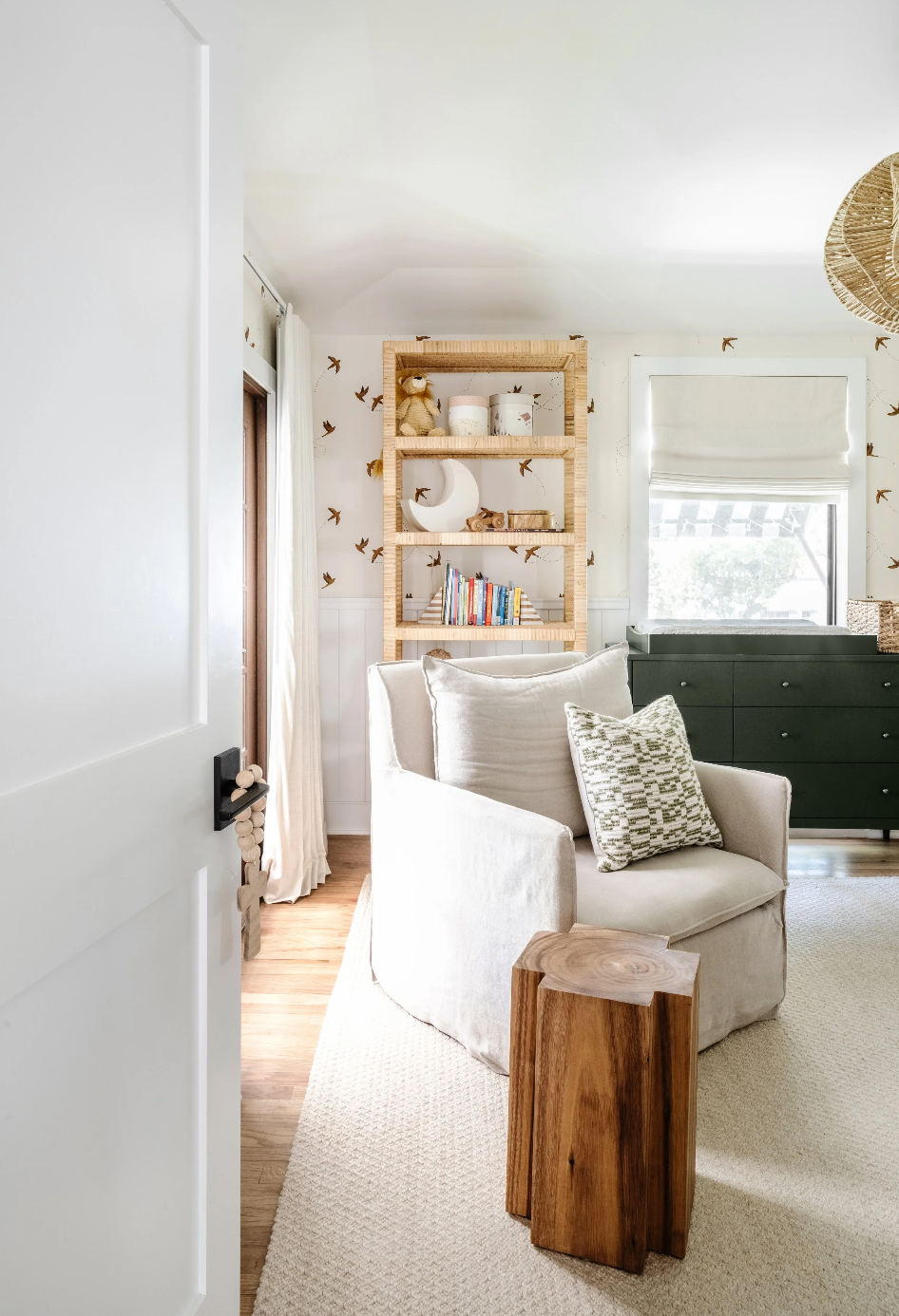 Slipcovered armchair and live-edge side table in the Spanish in the Gables nursery