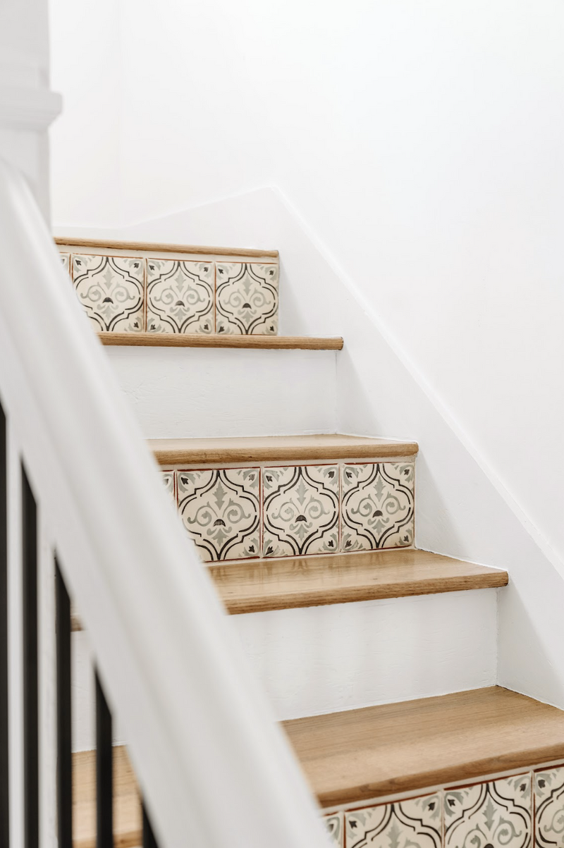 Staircase with patterned tile risers and white oak treads in the Spanish in the Gables remodel