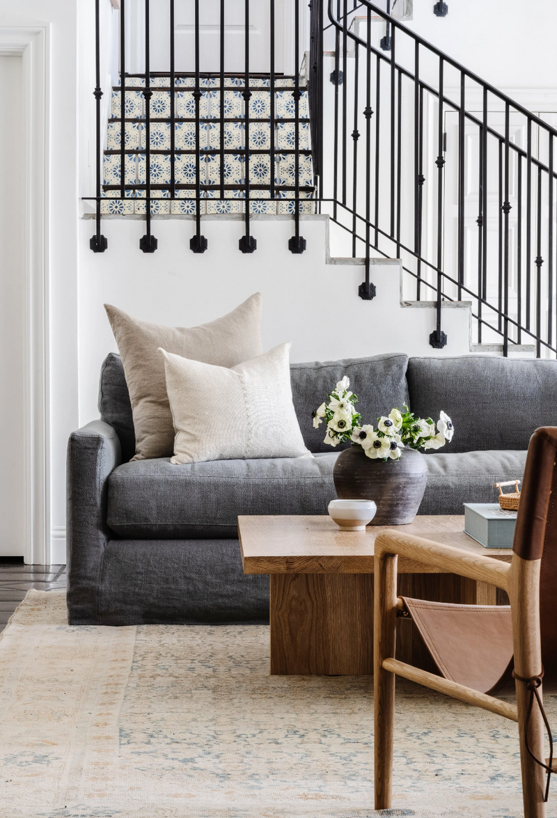 Living room with gray sofa, wooden coffee table, and decorative elements.