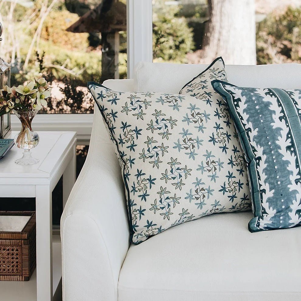 Maison Venu Celeste Lapis pillow with floral embroidery and hidden zipper on a white sofa