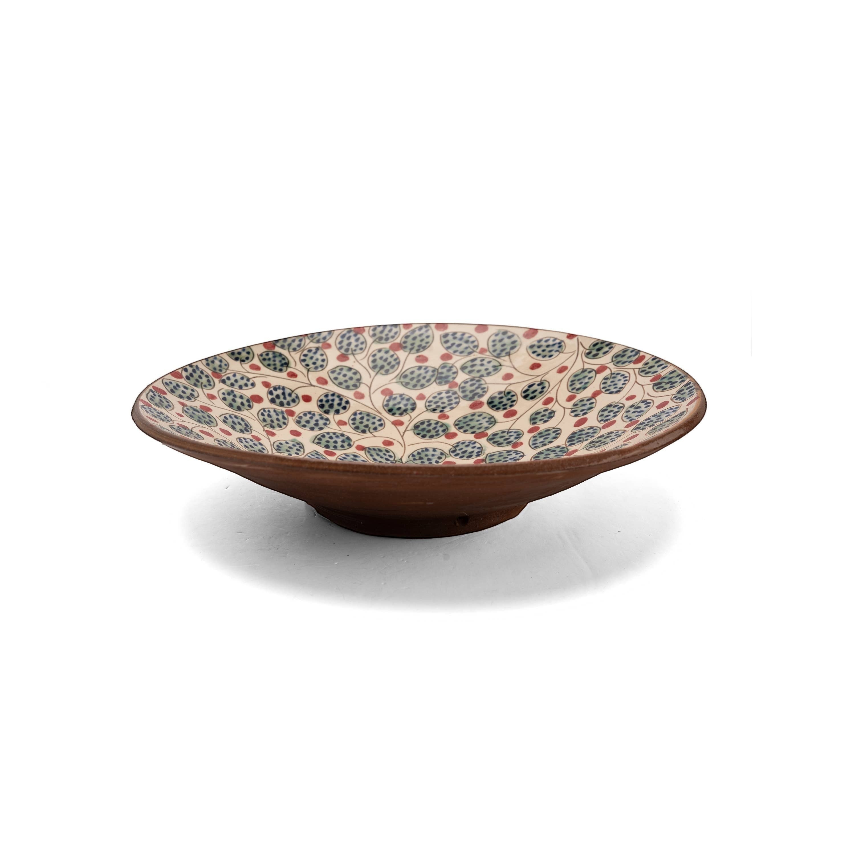 Kiliim handcrafted ceramic serving plate with hand-painted cherry and leaf motif in blue, green, and red.