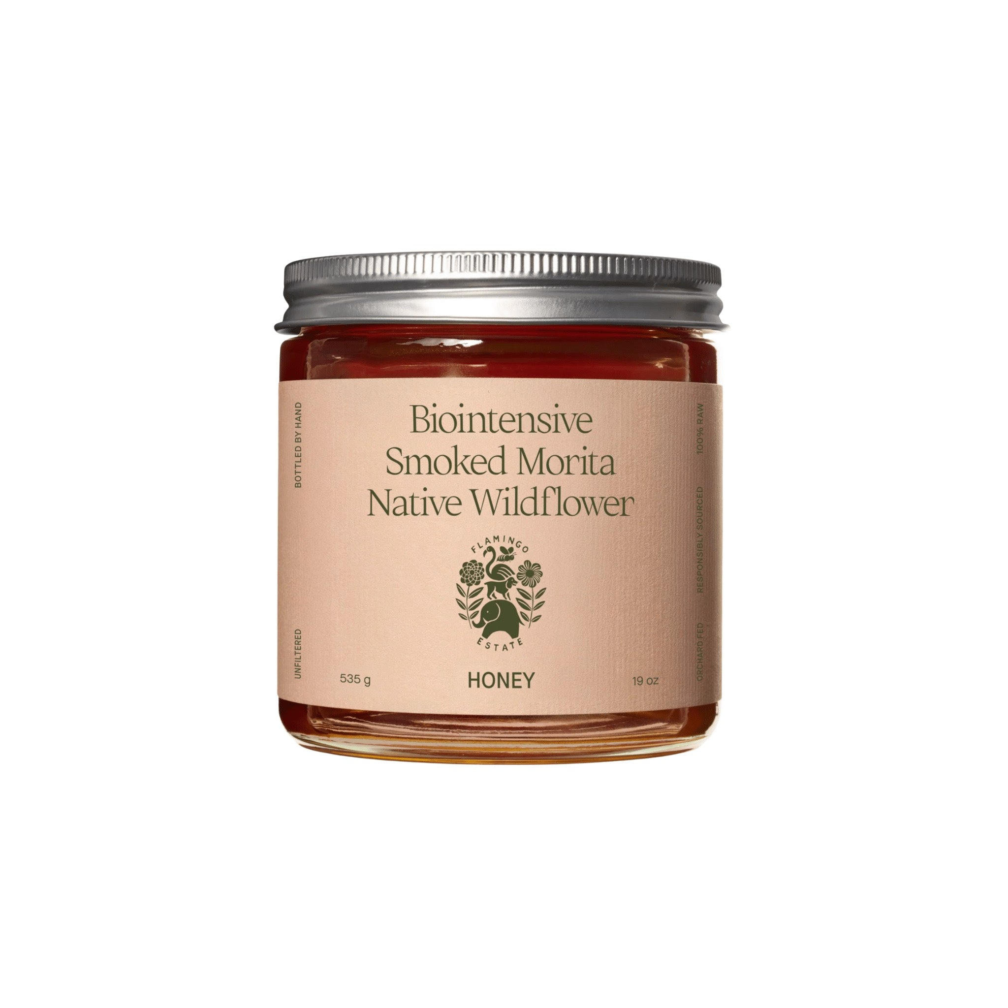 A clear Flamingo Estate Smoked Morita Native Wildflower Honey jar, 535 g, 19 oz, with a silver lid and deep red-amber honey, on white.