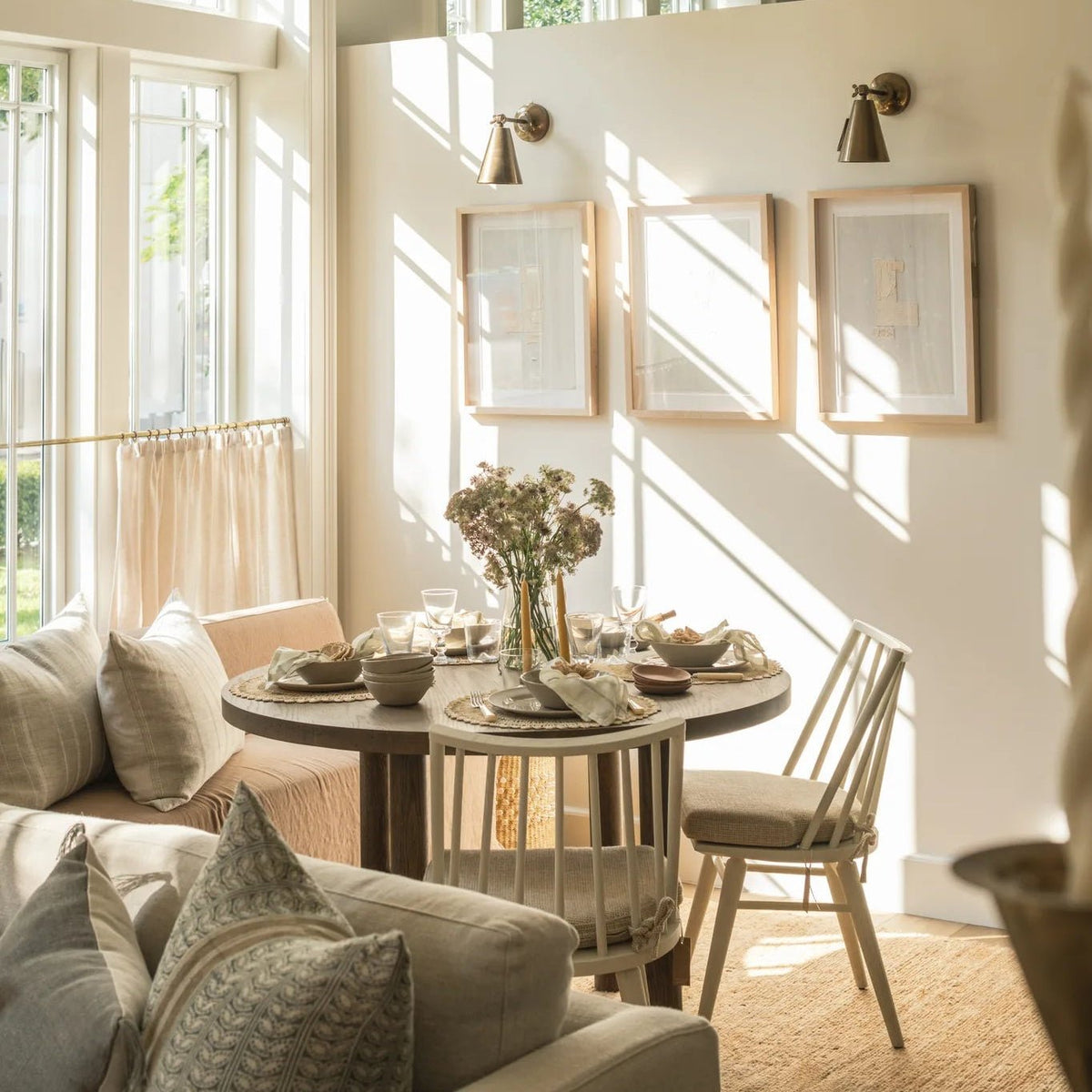 Galactic Triptych I with brass sconces above the Valencia X Dining Table and Lewis Windsor chairs