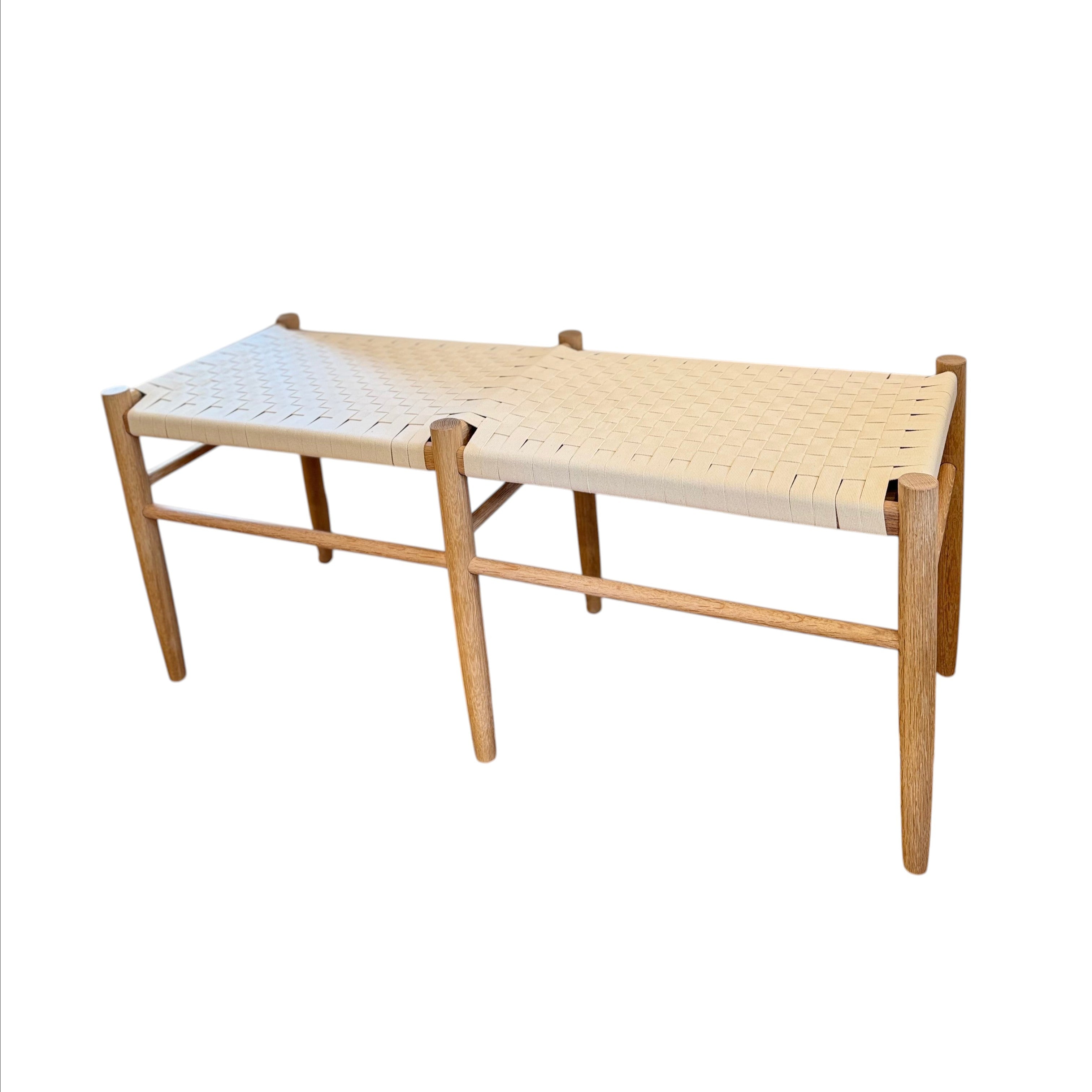 Calimia Home Gaon bench featuring a solid white oak frame and a handwoven white canvas ribbon seat.