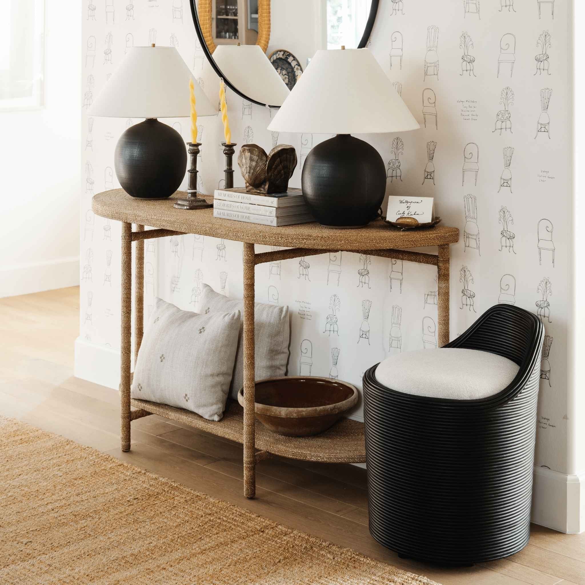 Isak Taupe Pillow styled on a neutral sofa — cross-embroidery detail in warm taupe linen, feather-down insert included