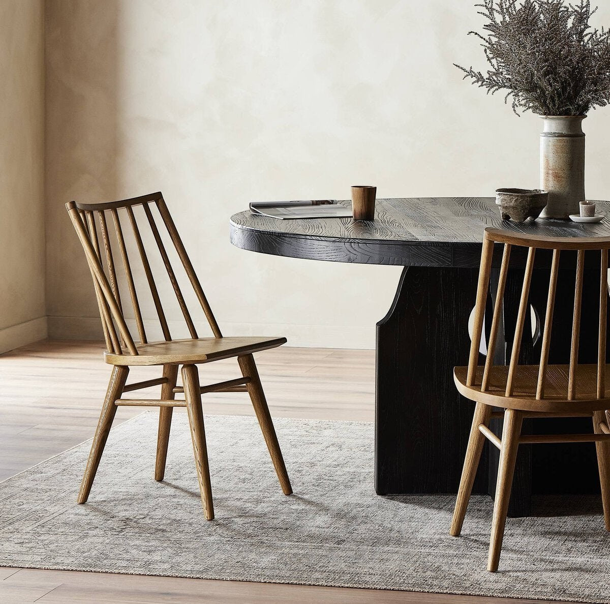 Calimia Home Lewis Windsor chair in oak with wire-brushed graining, shown in a contemporary dining room setting.
