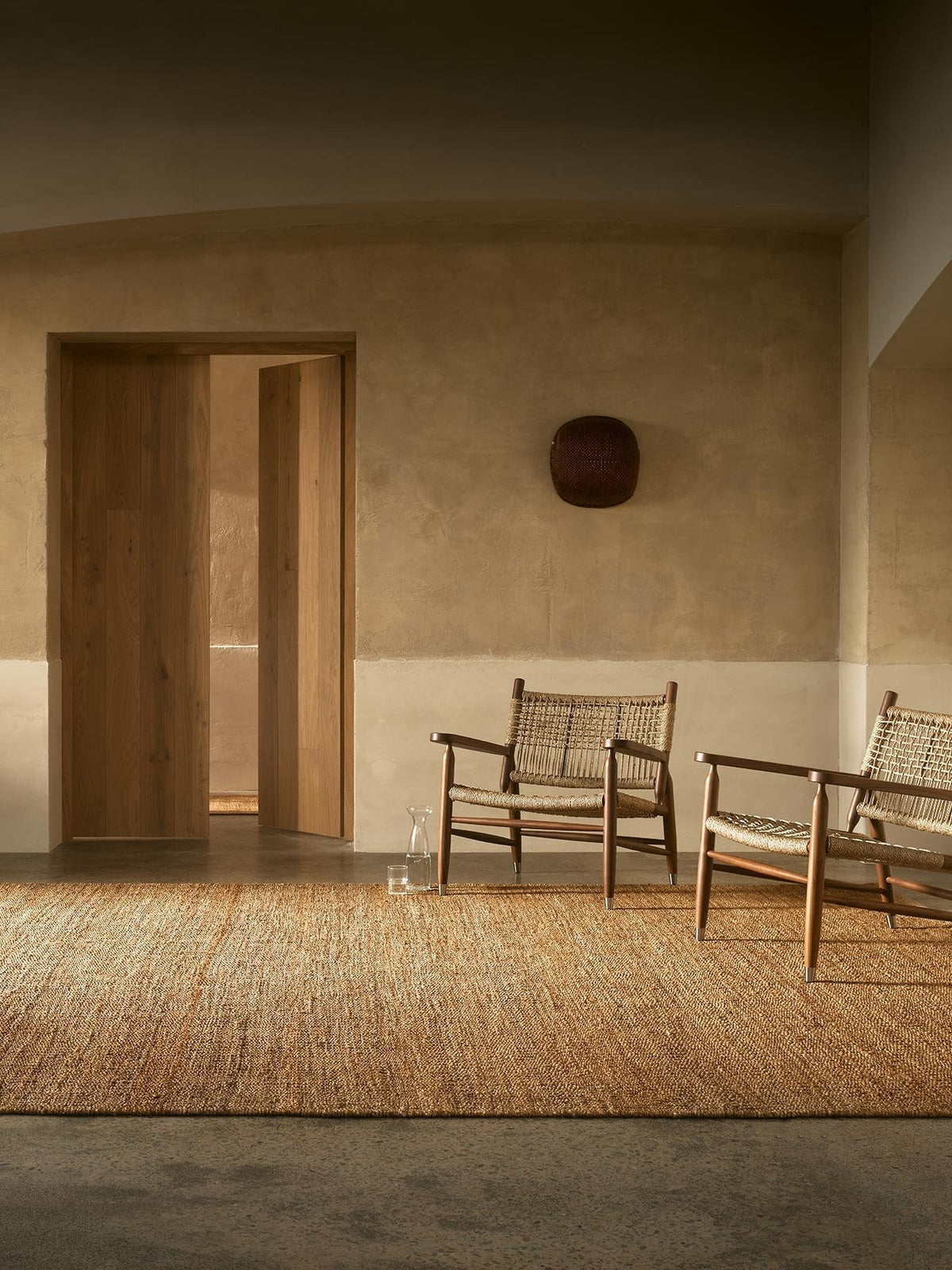 Armadillo Nest Rug in Natural, handwoven jute flatweave rug shown in a room setting