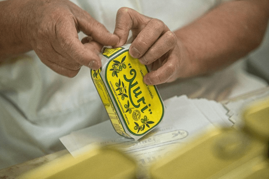Open Nuri Sardines tin showing olive oil and sardines