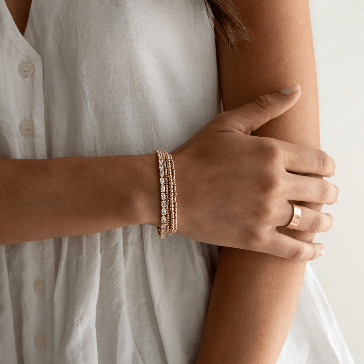 Oval tennis bracelet styled on wrist
