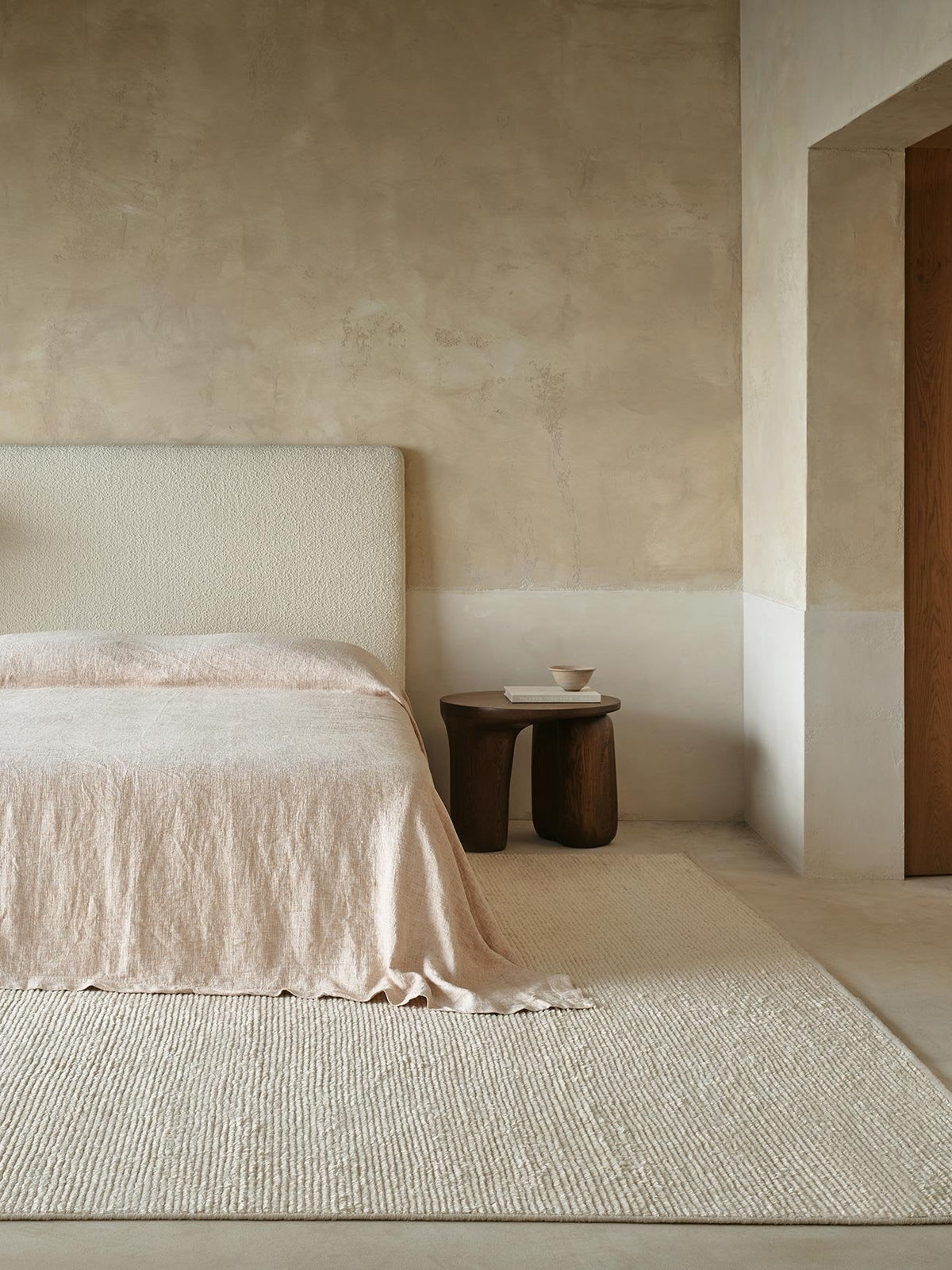 Armadillo Palermo Rug in Bone, hand-knotted linen rug shown in a room setting