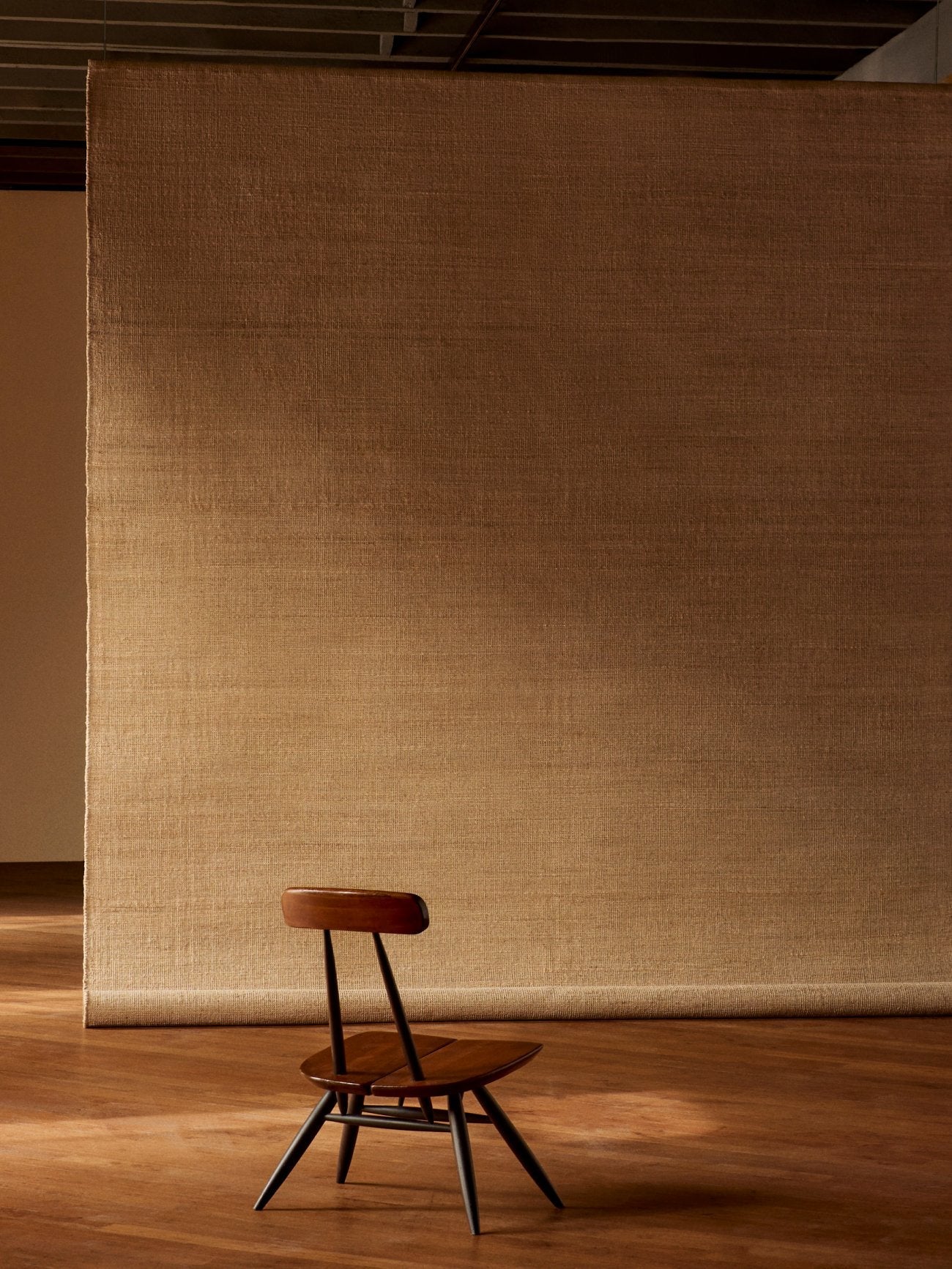 Armadillo Palloza Rug in Rattan, handwoven jute flatweave rug shown in a room setting
