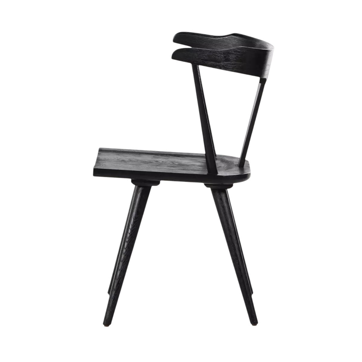Calimia Home Ripley dining chair in matte black solid wood with a sculptural mid-century silhouette and tapered legs.