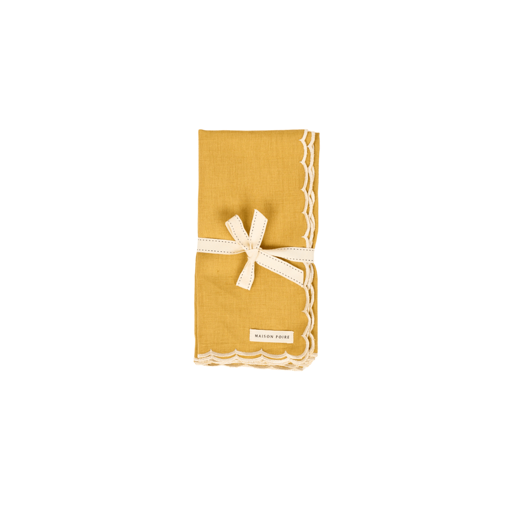 Maison Poire mustard cotton linen napkin with an ivory scalloped edge, folded and tied with ribbon