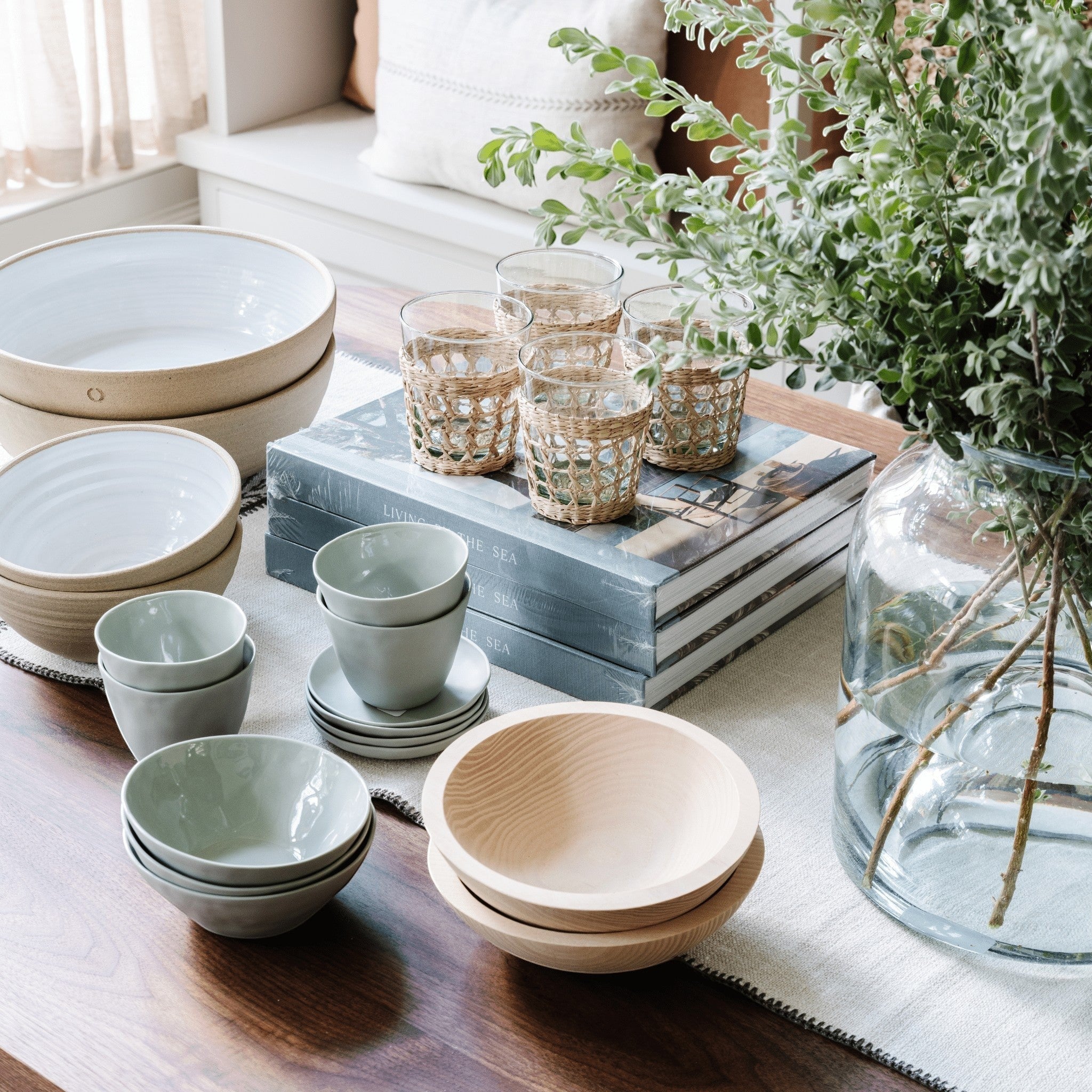 Be Home Seagrass Cage Tumbler set with clear glass and removable handwoven natural seagrass wrap on a table
