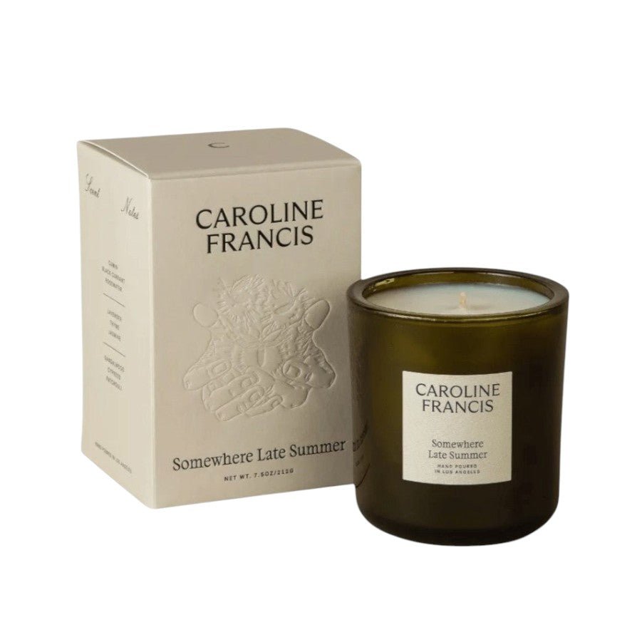 Caroline Francis candle and packaging on a beige background