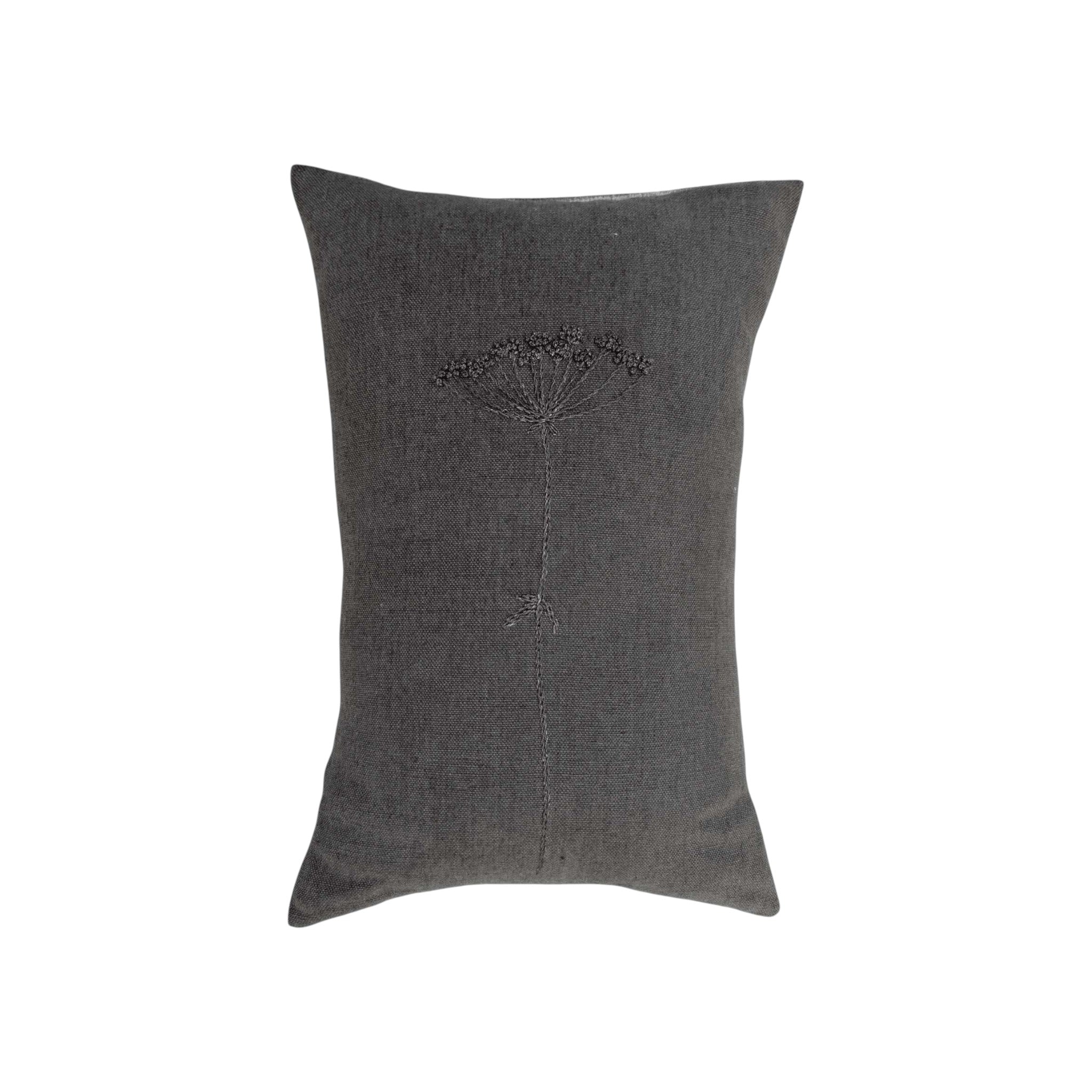 Wildflower Charcoal Lumbar Pillow by One Bi One — hand-embroidered wool wildflower motif on Belgian linen in deep charcoal, handcrafted in Gothenburg, Sweden