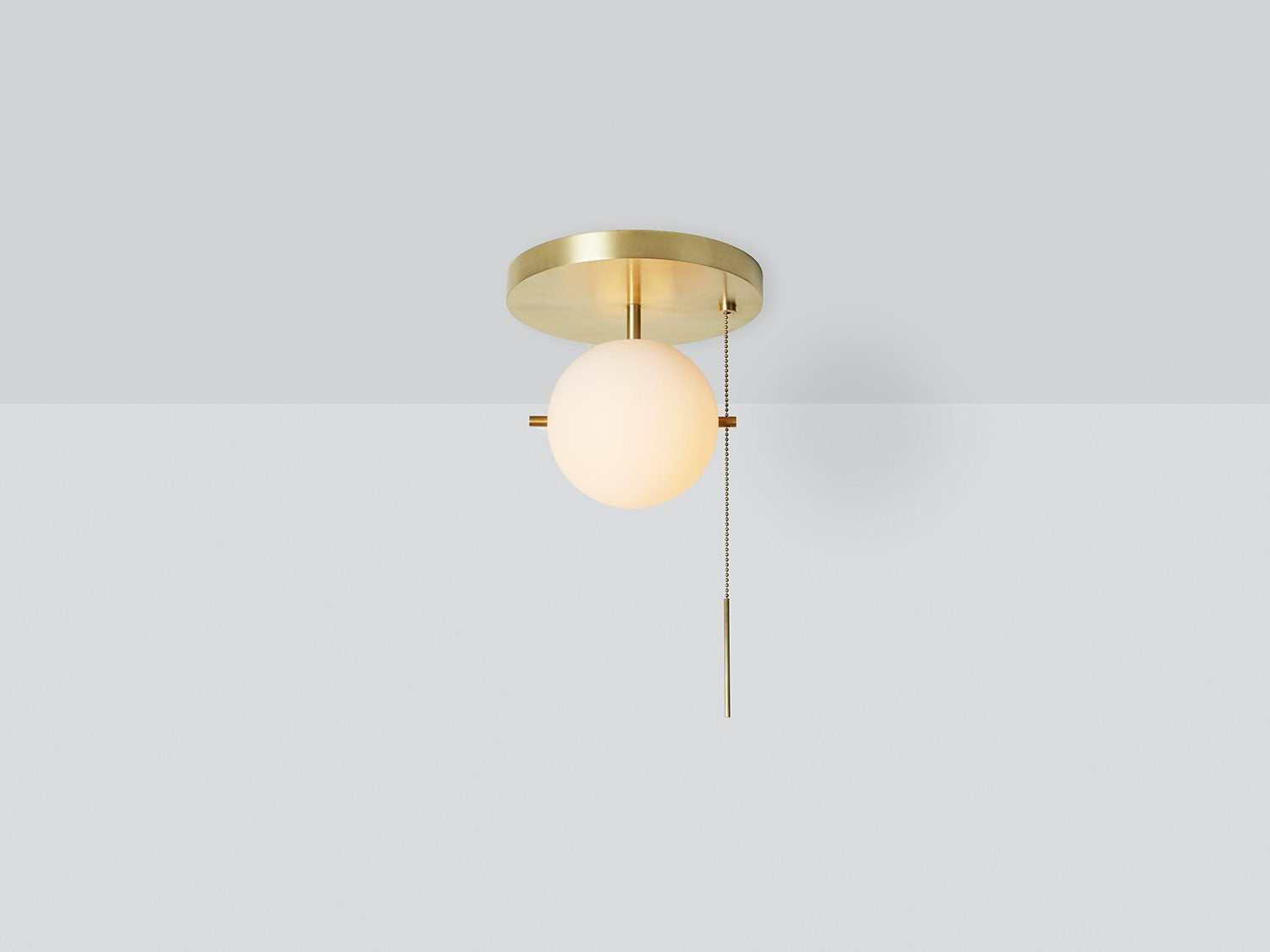 Workstead Signal Pendant Flush Mount in Hewn Brass, illuminated