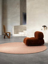 Armadillo Braid Rug in Blush, hand-braided wool blend rug shown in a room setting