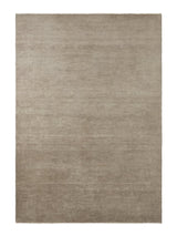 Armadillo Thatch Rug in Concrete, a second view of the hand-knotted wool rug in a styled interior